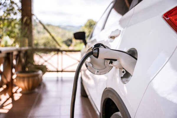 Charging,An,Electric,Car,In,A,Country,House